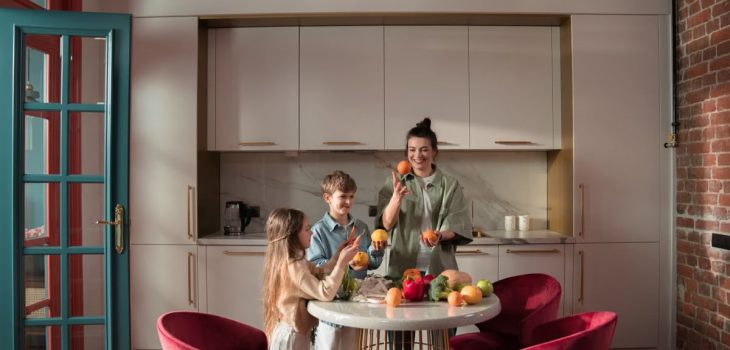 Mother with children preparing meals with fresh ingredients in a modern kitchen.